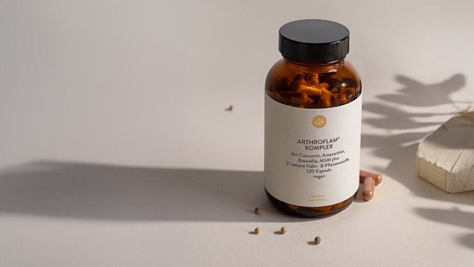Nahaufnahme einer Flasche Arthroflam Komplex von Sunday Natural auf einem cremefarbenen Untergrund.